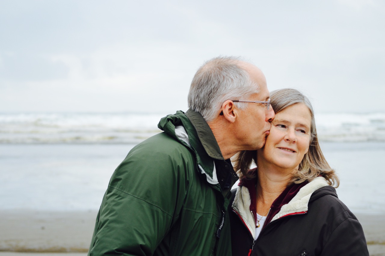 Older couple walking on beach